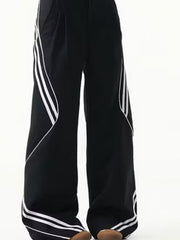 Men's black wide leg track pants with white stripe accents and a comfortable fit.