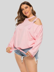 Blush pink long sleeve blouse with shoulder buckle cutout and tie front detail.