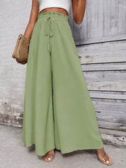 Light green ruffled waistline palazzo trousers with drawstring waist and wide legs.