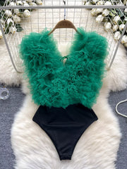 Green ruffled V-neck bodysuit with lace detail and black bottom