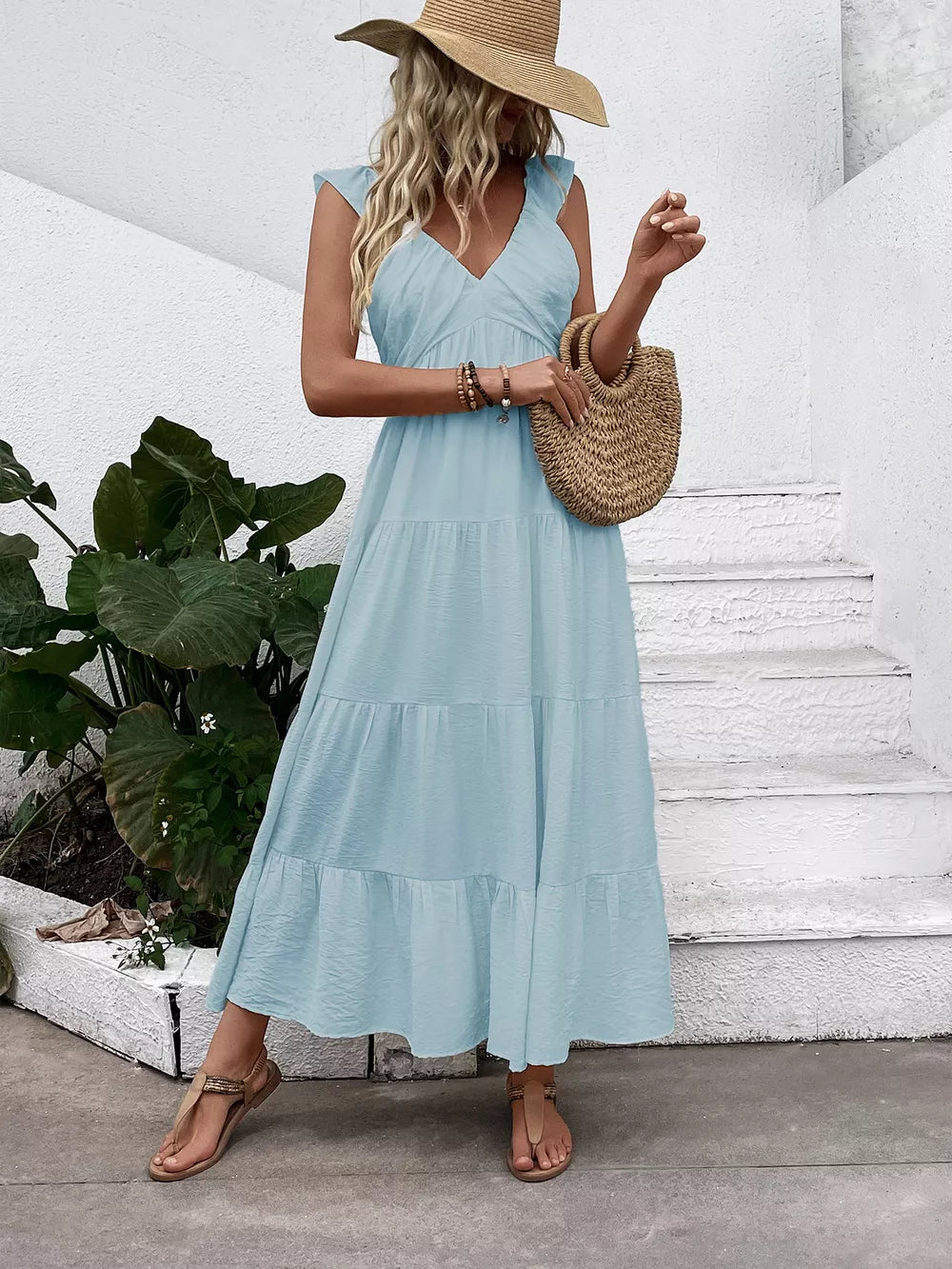 Light blue tiered maxi dress with flutter sleeves and V-neck.