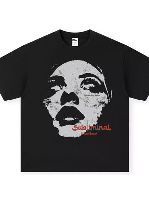 Black oversized graphic tee with a distressed face print and red "Subliminal Break Silence" text.