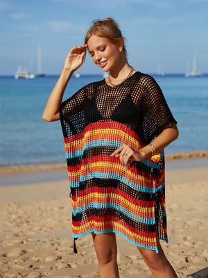 Black crochet beach poncho with rainbow stripes, short sleeves, and tasseled hem.