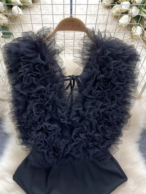 Black ruffled V-neck bodysuit with lace detail and tie closure
