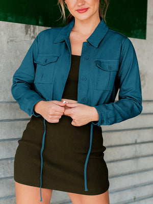Peacock blue cropped utility jacket with drawstring hem and buttoned chest pockets.