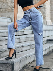 Ripped high-waisted light wash denim jeans with button closure and straight leg cut.