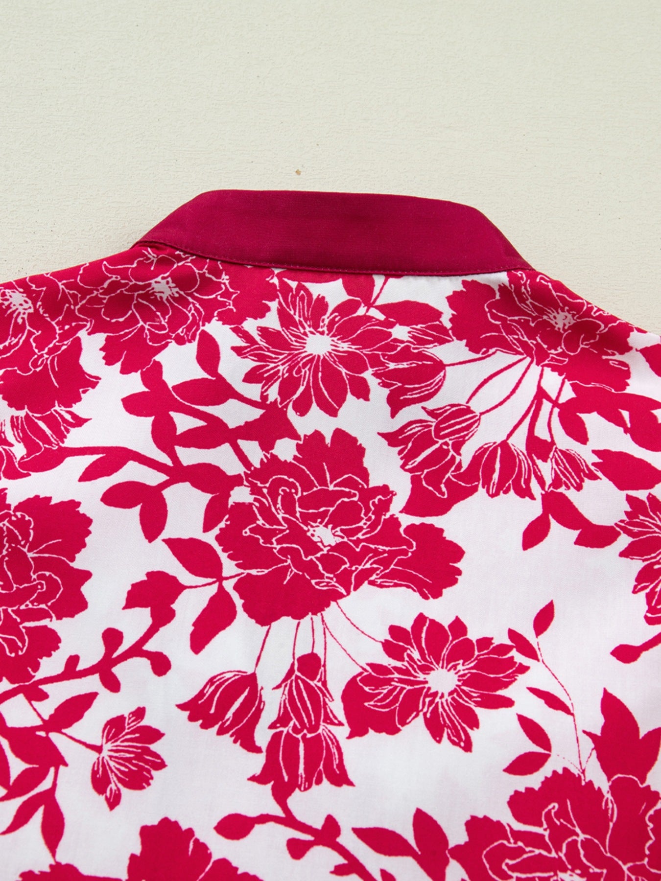 Floral print polyester blouse with lace detail and a contrasting collar.