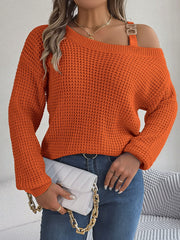 One-shoulder knit sweater in pumpkin orange with buckle detail and waffle texture.