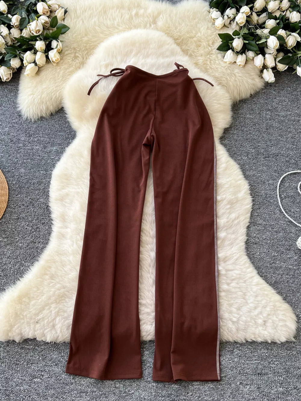 Brown maternity wide-leg pants with tie waist and contrast side stripe detail.