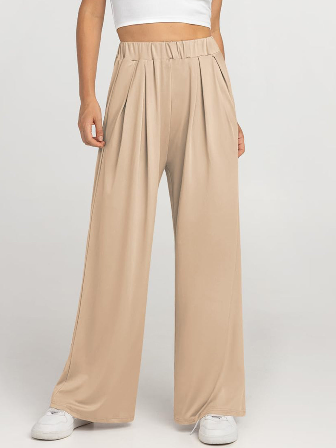 Pleated palazzo trousers in taupe with pockets and elastic waistband.