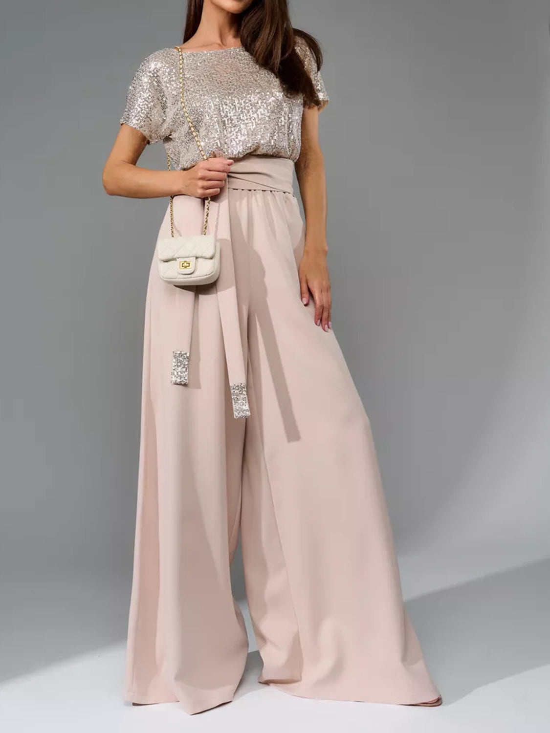 Sequin bodice and dusty pink palazzo pants with belted waist.