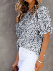 Maternity floral print blouse with smocked bodice and ruffle sleeves in gray.