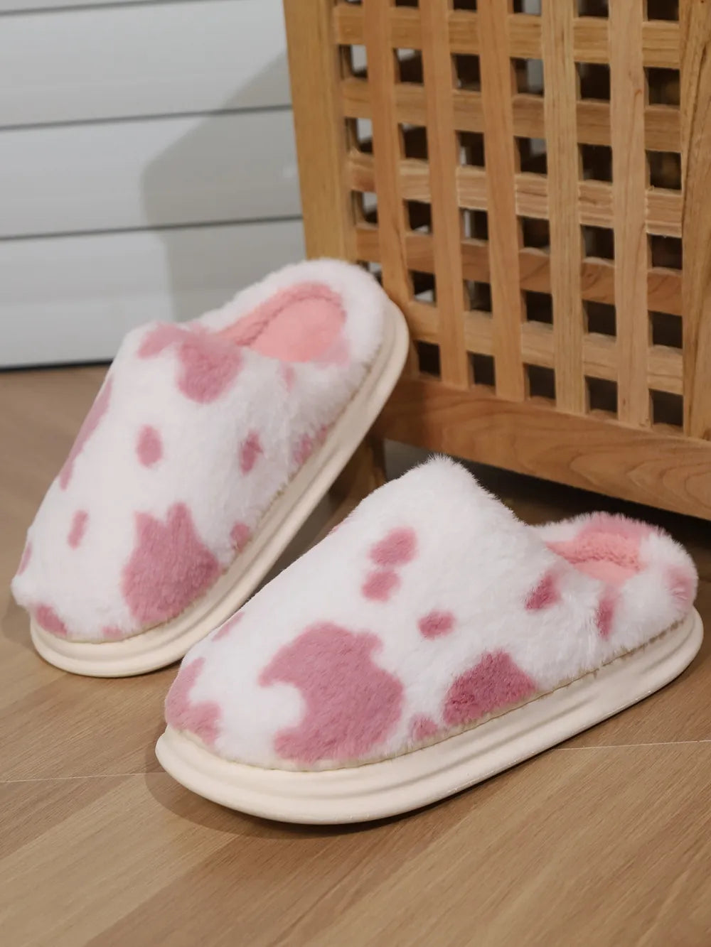 Blush pink cow print faux fur house slides with plush lining and thick sole.