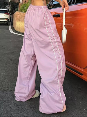 Pink wide-leg maternity pants with gathered waistband and white side stripe detail.
