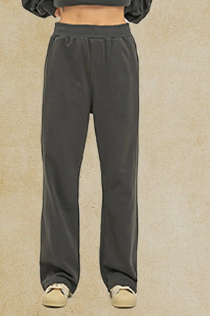 Dark gray seamed lounge trousers with a relaxed fit and elastic waistband.