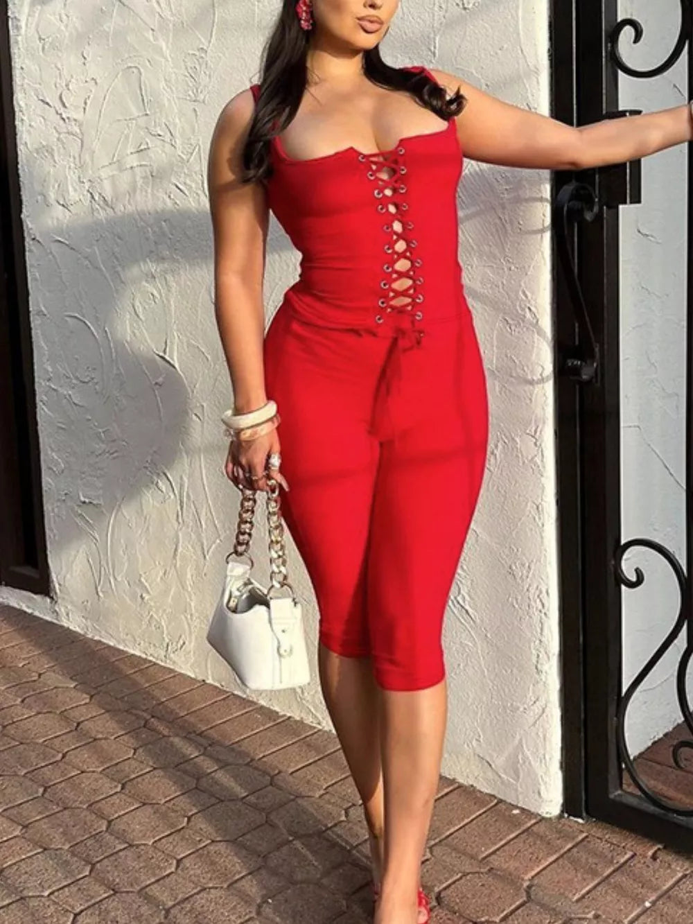 Red lace-up tank top and capri pants set with drawstring detail.