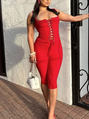 Red lace-up tank top and capri pants set with drawstring detail.