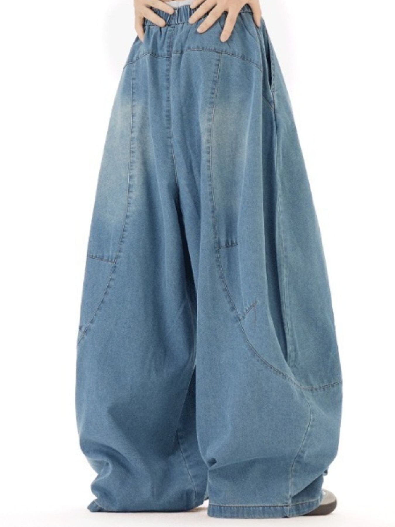 Men's light wash denim jeans with a wide leg and elastic waistband.