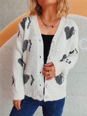 White acrylic knit cardigan with black heart motif, button front, V-neck.