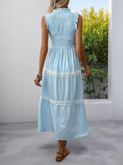 Blue striped sleeveless midi dress with smocked bodice and lace trim tiers.