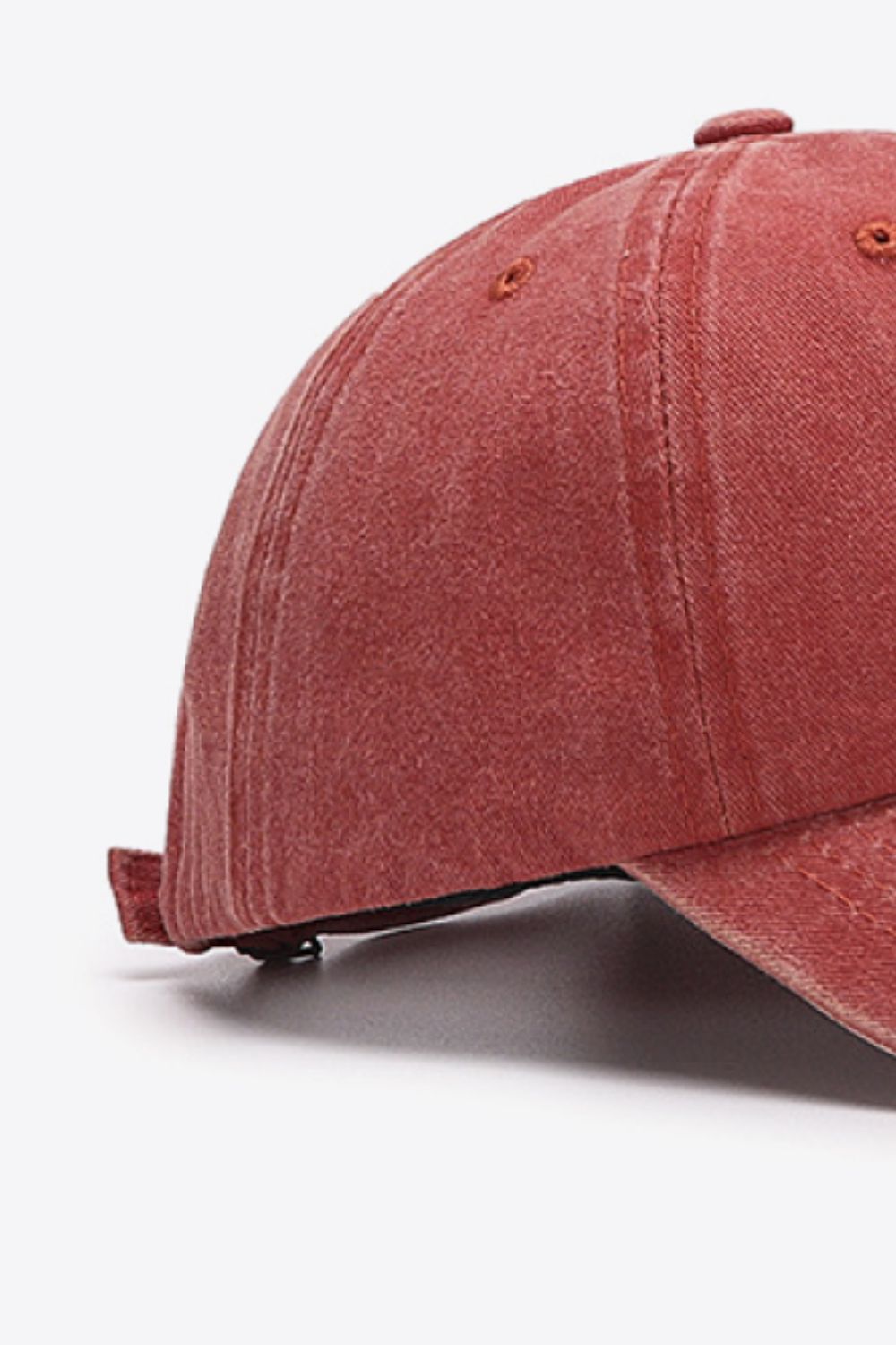 Washed cotton baseball cap in red with visible stitching details.