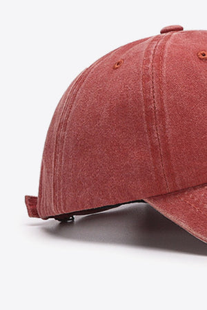 Washed cotton baseball cap in red with visible stitching details.