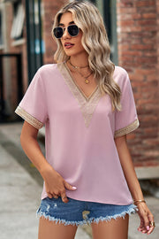 Blush pink v-neck blouse with lace trim on neckline and sleeves