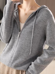 Gray ribbed knit zip-through hoodie with drawstring and front pockets.