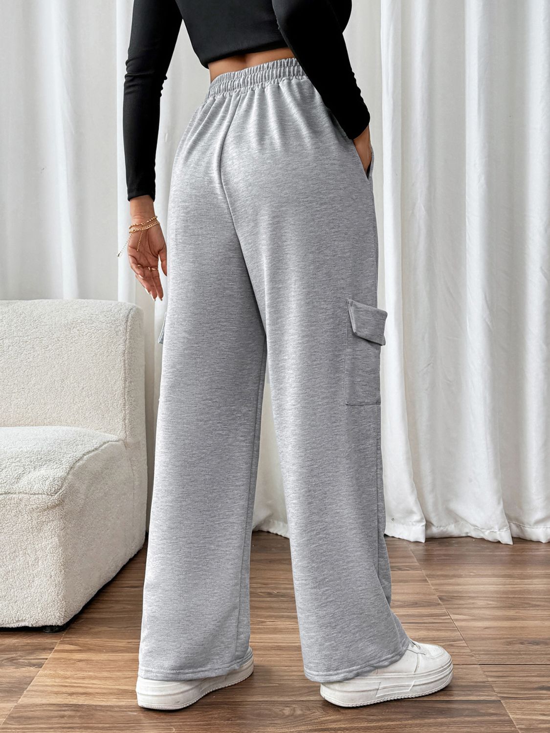Light gray wide-leg sweatpants with cargo pockets and an adjustable waist.