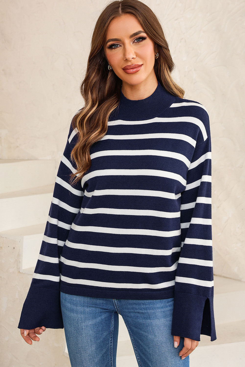 Navy and white striped mock neck sweater with bell sleeves and side slits.