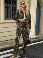 Leopard print denim jacket with button front and collar, styled with matching pants.