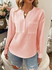 Blush pink textured henley blouse with two chest pockets and button placket.