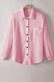 Blush pink waffle knit button-down shirt jacket with a chest pocket and button closure.