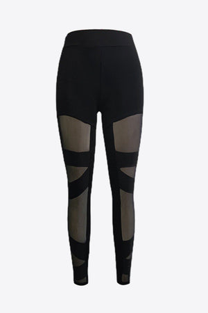 Black leggings with geometric mesh panels on the legs.