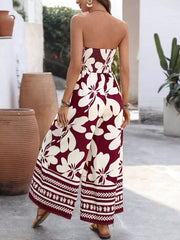 Burgundy floral strapless romper with wide legs and smocked bodice detail.