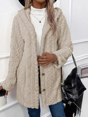 Apricot fuzzy hooded trench coat with button detail and textured pattern.