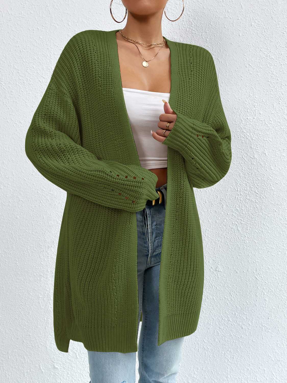 Longline knit open cardigan in green with ribbed details and subtle cutouts on the sleeves.