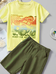 Yellow cotton t-shirt with monster truck graphic and green shorts.