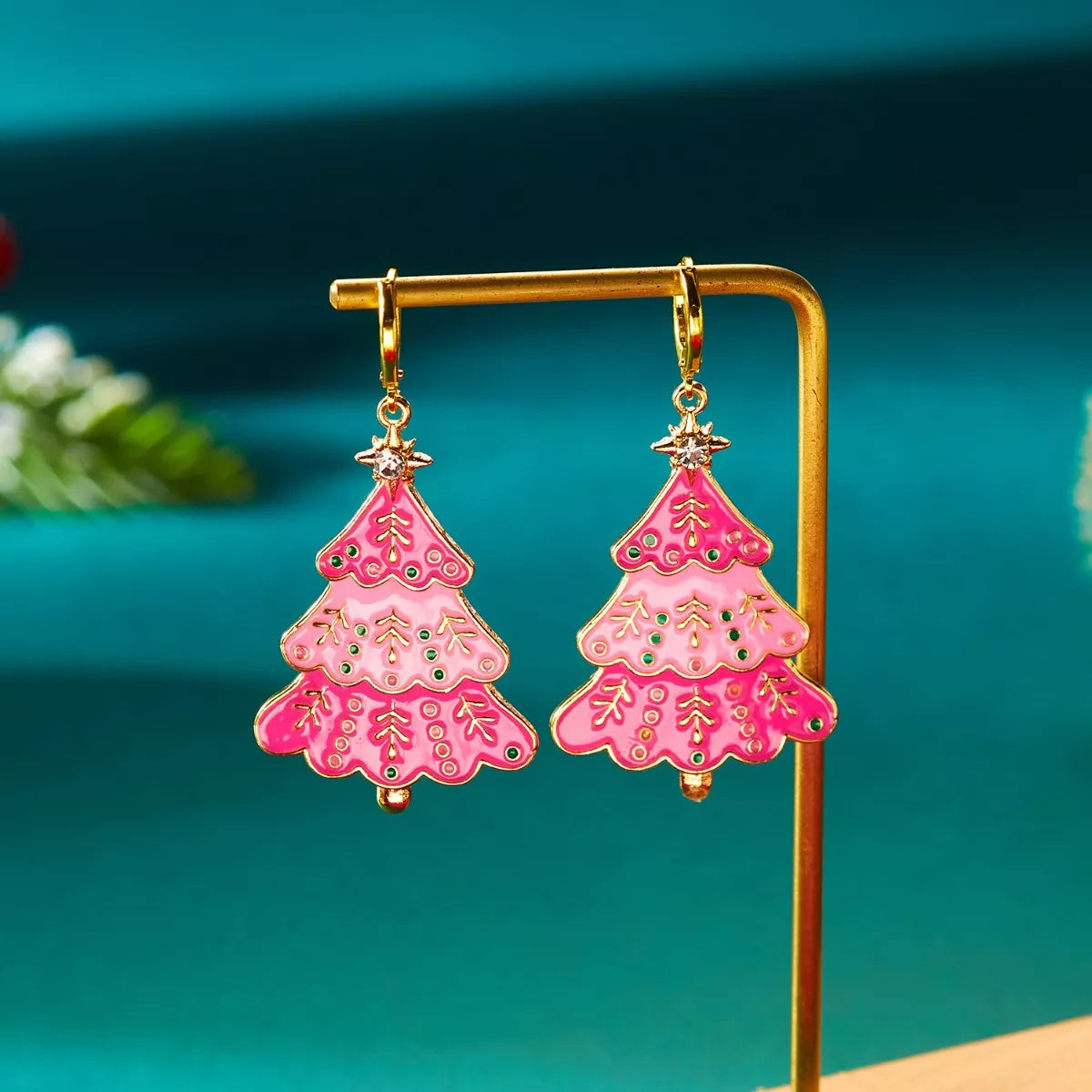 Christmas tree dangle earrings in blush pink with festive details and gold accents.