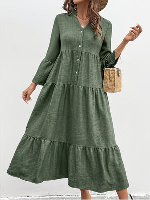 Green tiered midi dress with button front, bell sleeves, and textured cotton blend fabric.