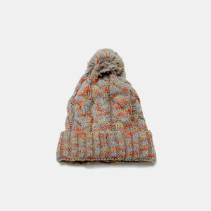 Textured knit beanie with pom in multi-color marled yarn and cable knit pattern.