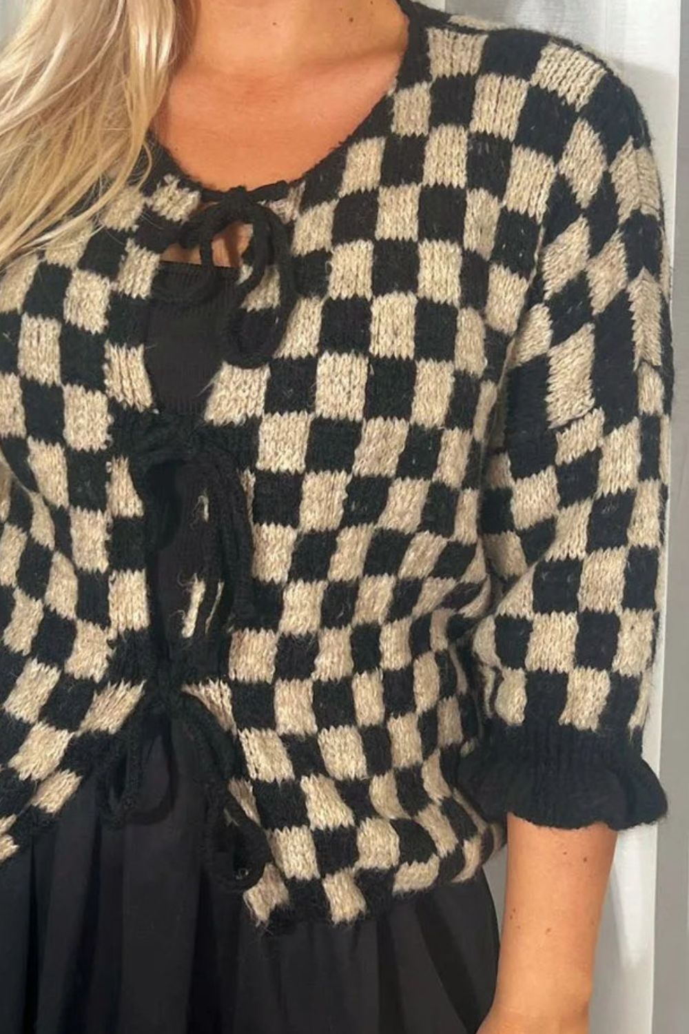 Black and taupe checkered knit cardigan with tie-front and ruffle sleeves