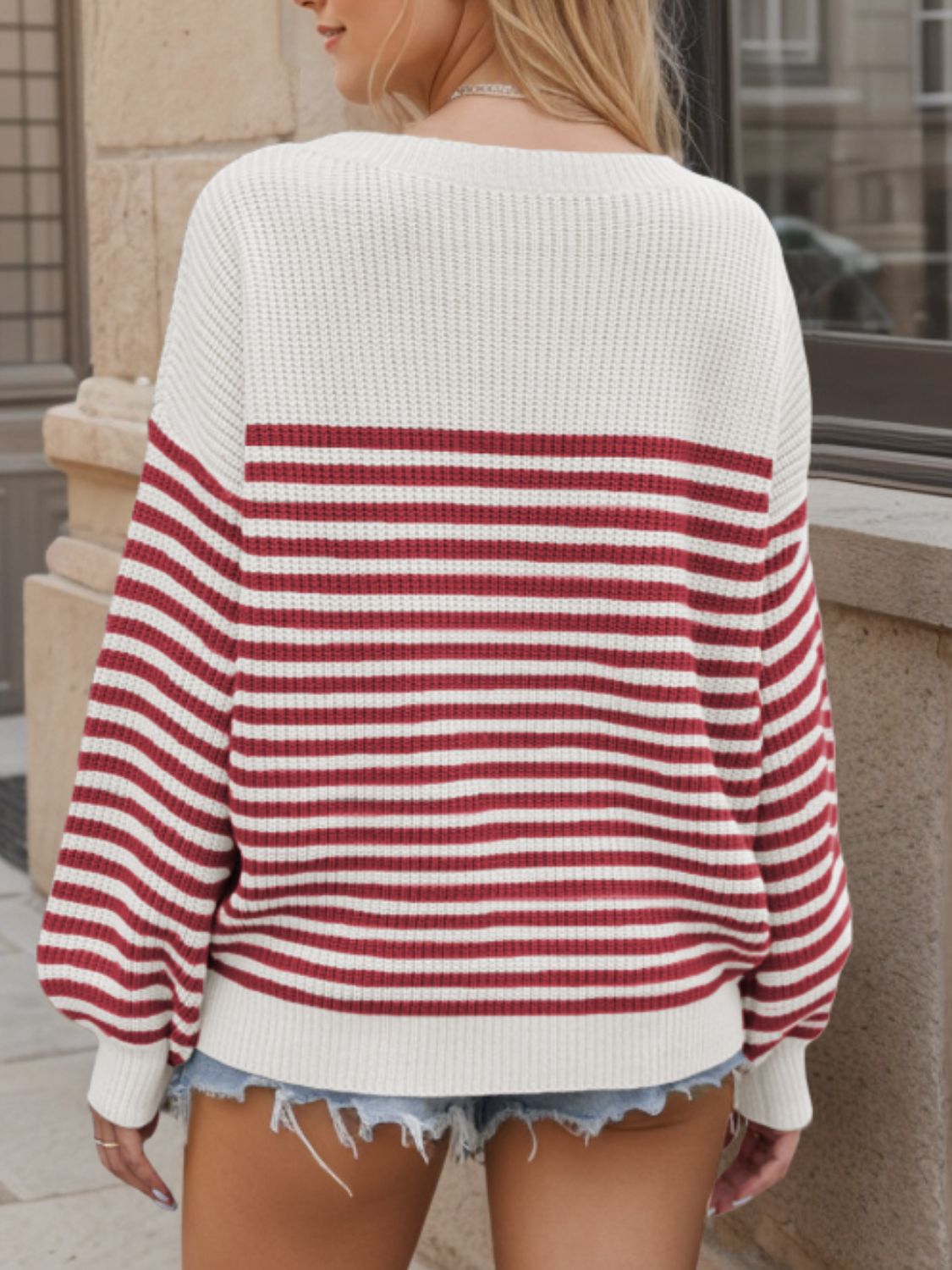 Horizontal stripe drop shoulder knit sweater in cream and burgundy with balloon sleeves.