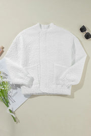 White quilted bomber jacket with floral pattern and two front pockets.