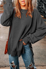 Oversized charcoal washed cotton sweatshirt with side slits and crew neck.