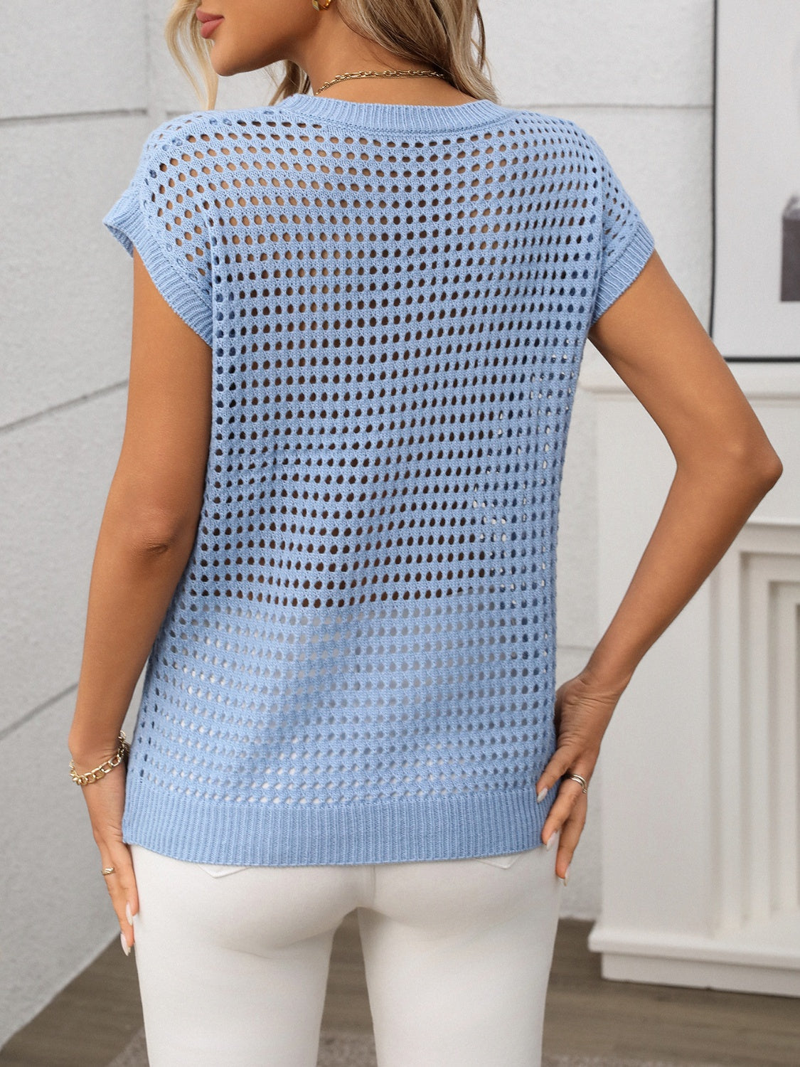 Light blue openwork knit crewneck top with short sleeves.