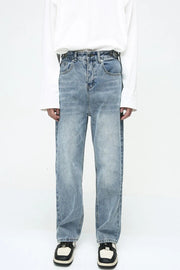 Vintage wash relaxed fit denim jeans in medium blue with button fly.