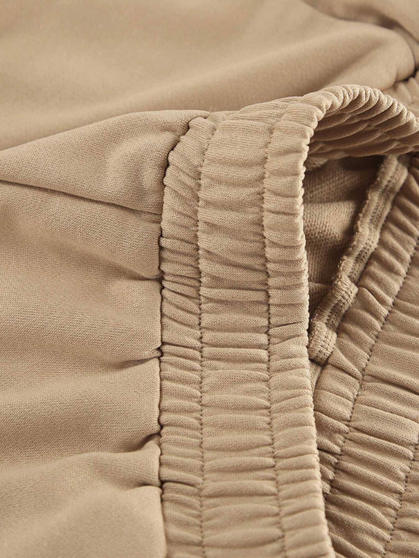 Camel quarter zip top and pants set detail with elastic waistband and drawstring.