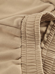 Camel quarter zip top and pants set detail with elastic waistband and drawstring.