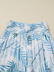 Tropical leaf print wide leg pants with smocked waistband and blue and white pattern.